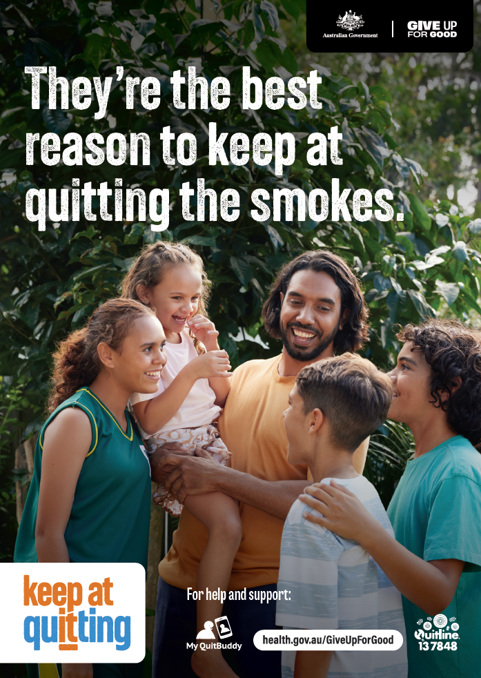 Man holding a child and surrounded by other children, with text above "They're the best reason to keep at quitting the smokes"