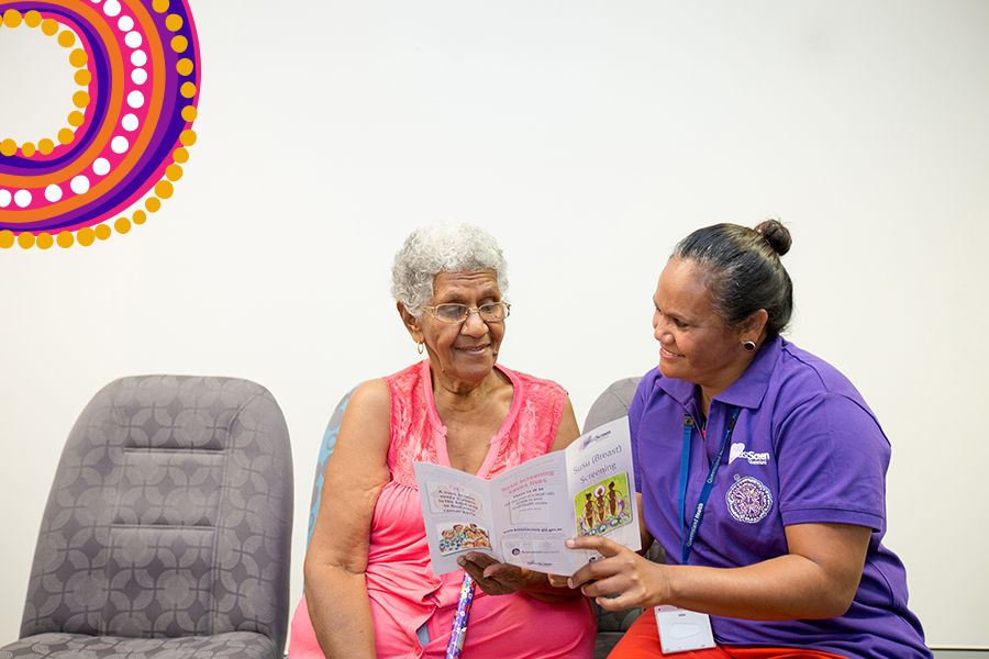 Two Aboriginal and Torres Strait Islander women seated and looking at brochure