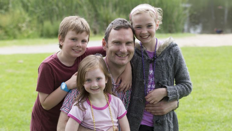 Family standing in a field