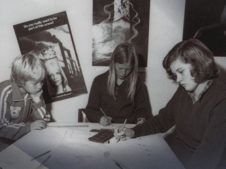 teenagers sit near anti-smoking posters in the 1970s