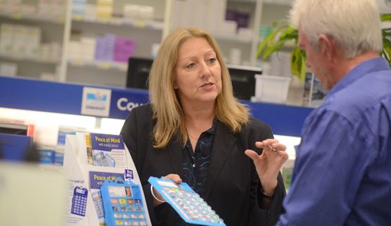 image of pharmacist and patient in pharmacy