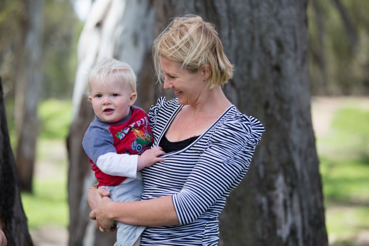 image of young woman with a baby in her arms