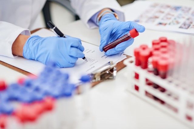Researcher with blood vials