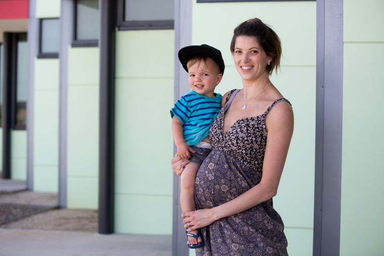 pregnant lady holding young boy
