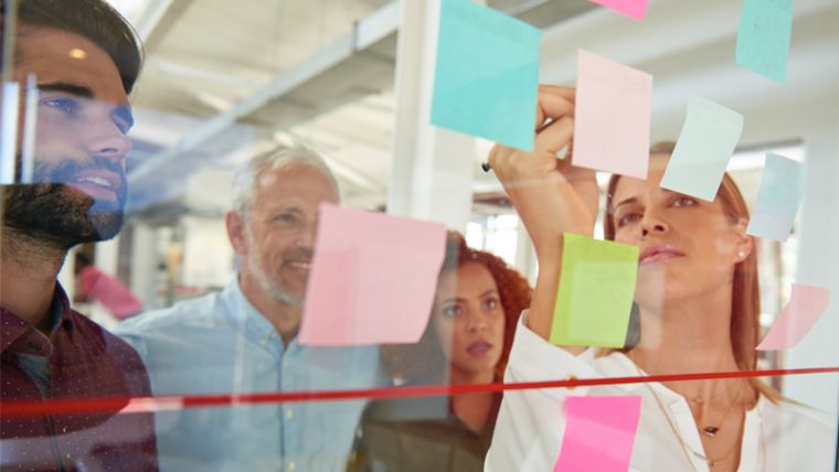 Group working at a glass noticeboard