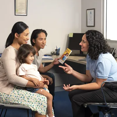 Parents and child talking with their medical practitioner