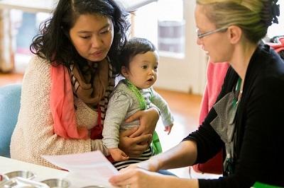 Image of a mother and child talking with a health professional
