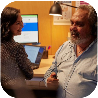 Man having hearing test conducted by female audiologist