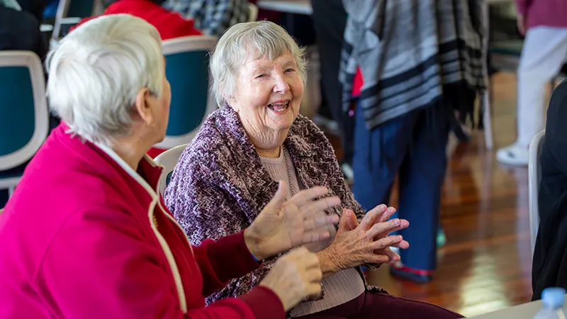 2 old ladies moving their hands