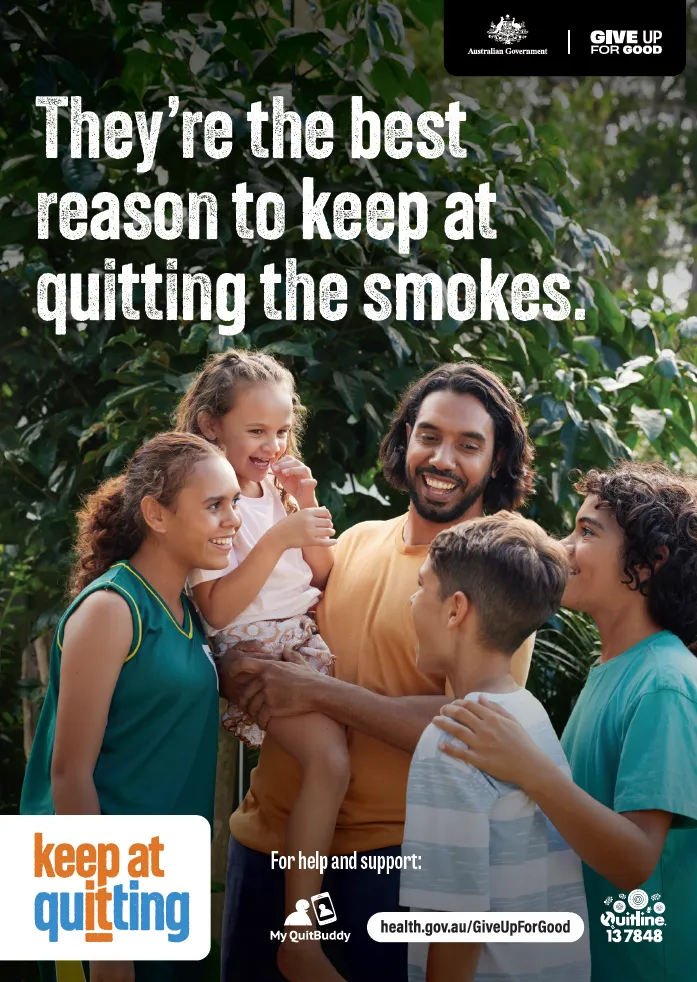 Man holding a child and surrounded by other children, with text above "They're the best reason to keep at quitting the smokes"