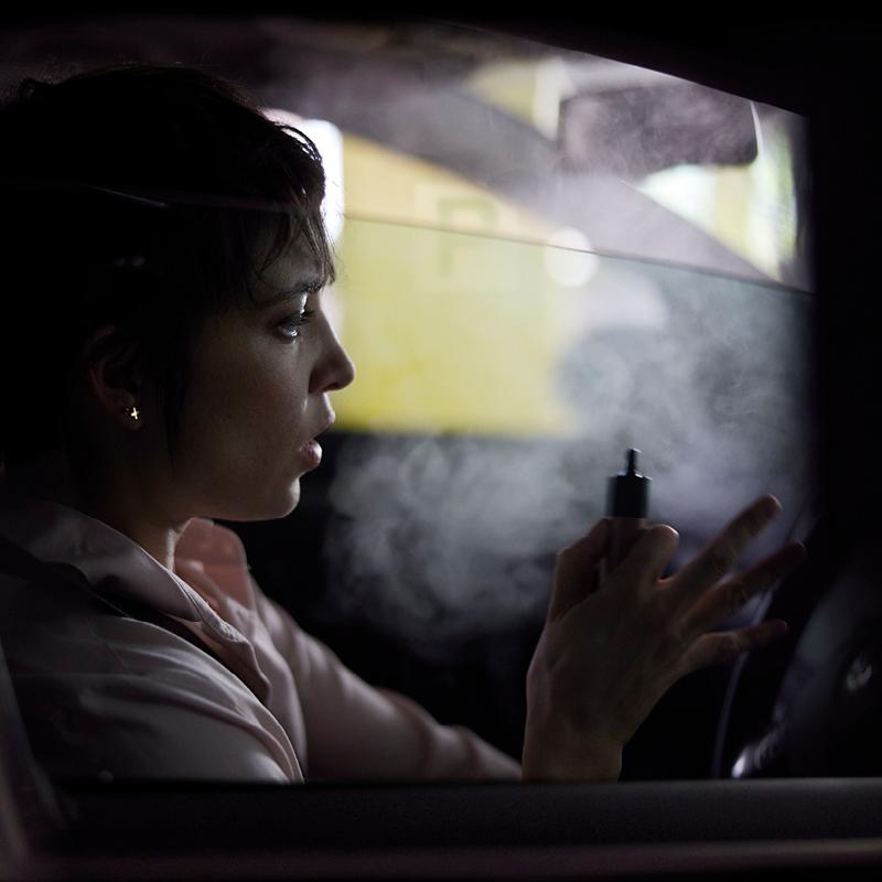 Woman vaping in a car