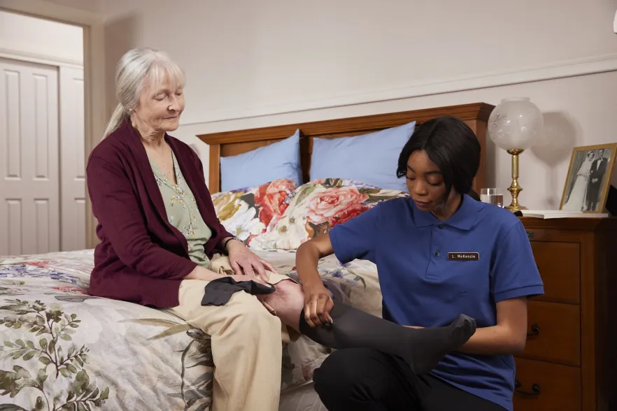 Aged Care Nurse attending female patient
