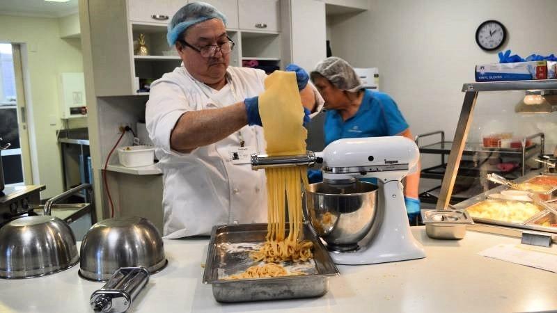 Darren Ho making fettucine in an aged care home kitchen