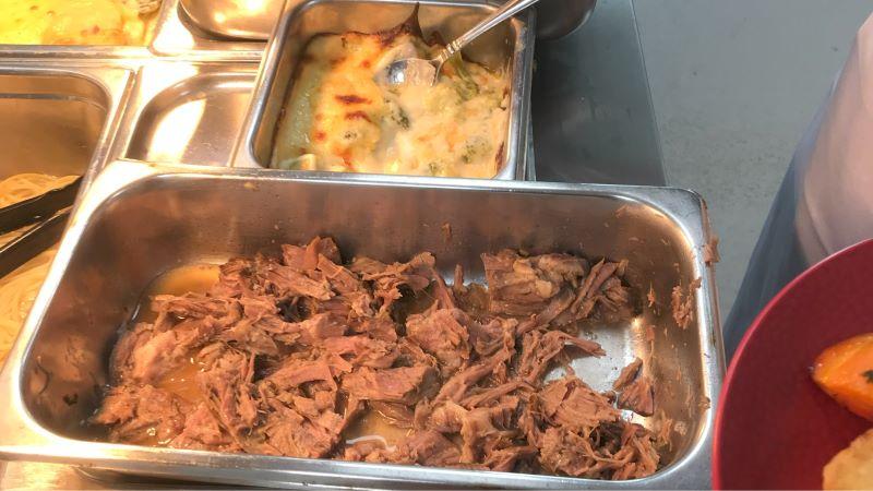 Metal tray full of slow cooked meat, as Heathcote Health uses a bain-marie to bring people into the dining room.