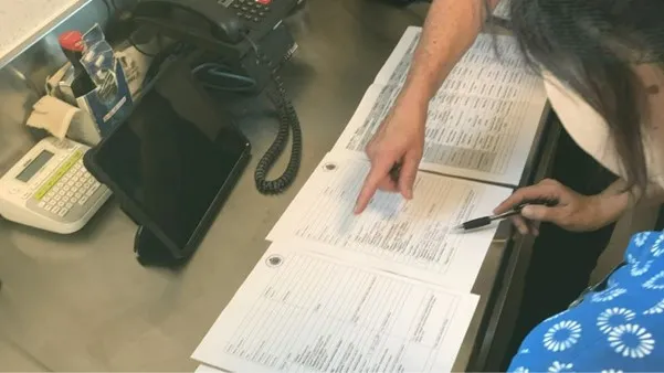 Kitchen staff preparing Heathcote Health’s menus with staff looking closely at paperwork