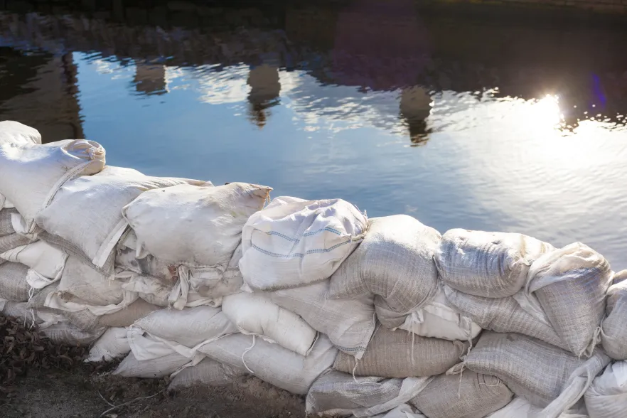 An image of sandbags holding back water