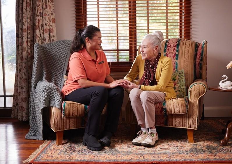 Elderly women talking to her female carer