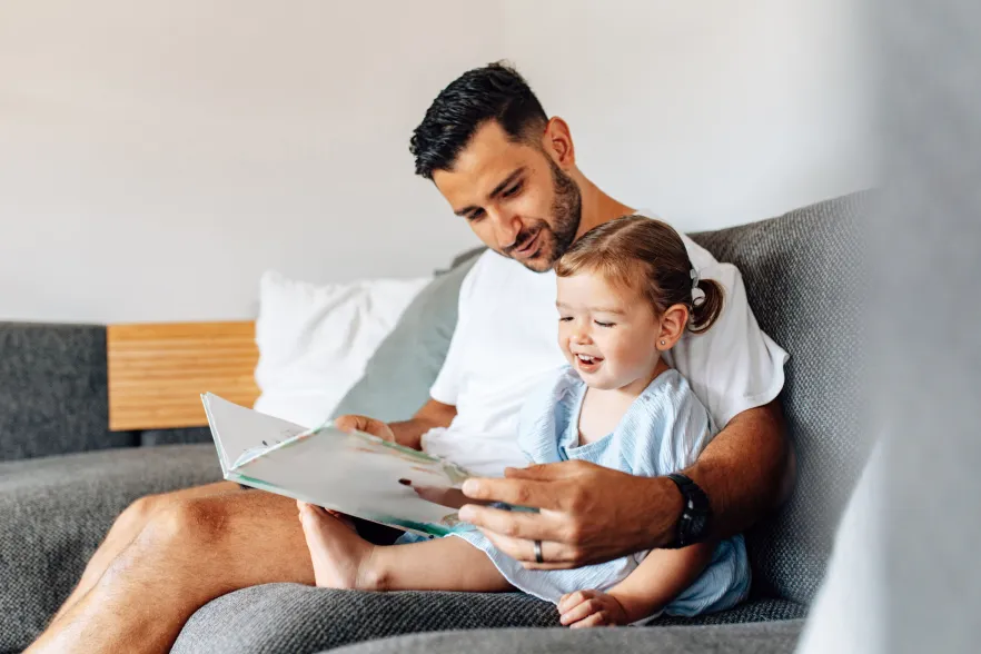 A father and child reading a book