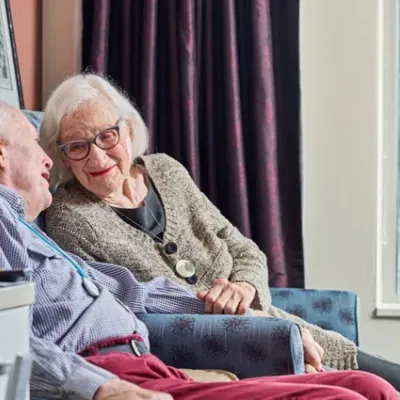 Elderly couple sitting and talking on their recliners