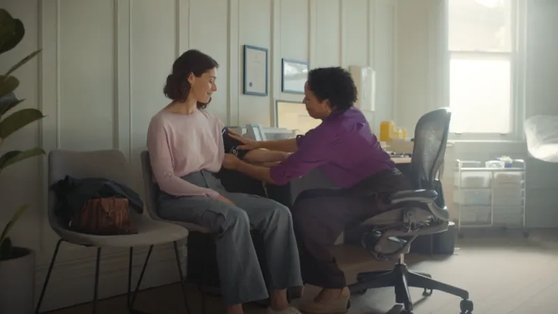 Woman at a doctor's office examined by a female GP
