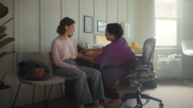 Woman at a doctor's office examined by a female GP