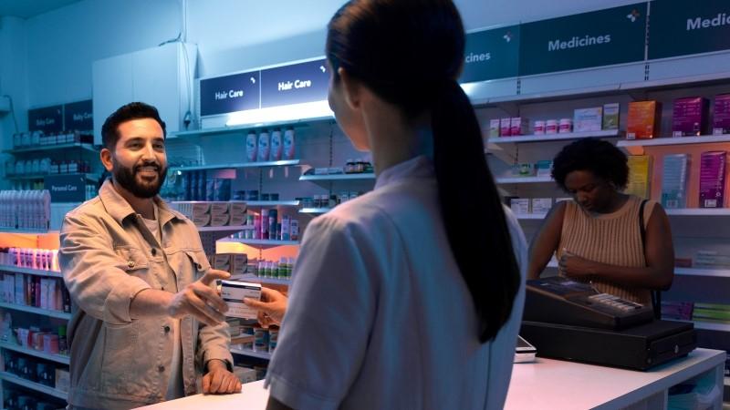 Man picking up medicines from a pharmacy