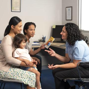 Parents and children talking with doctor