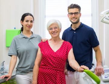An image of two aged care workers with an older lady