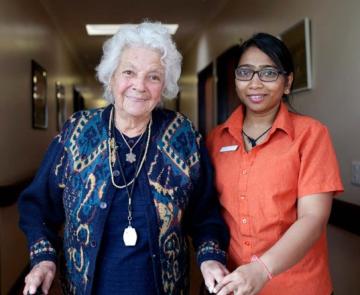 Older person and carer in corridor