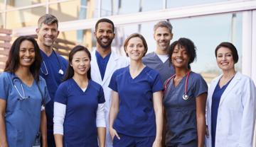 Diverse group of health workforce professionals such as nurses and doctors lined up