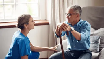 Senior man receiving support from a nurse