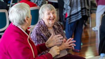 2 old ladies moving their hands