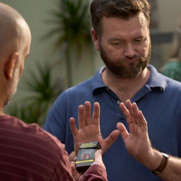 Image showing a man with his hand up refusing the offer of a cigarette from a packet being held by another man