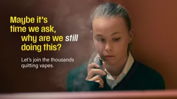 Girl vaping in a bathroom stall