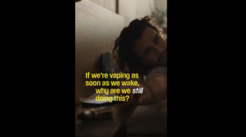Man reaching for a vape from bed