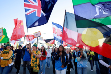 Crowd of people with Australian and Indigenous flags