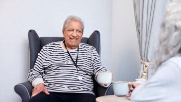 Photographic image of an older man with a cup of tea