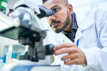 Image of a male looking into a microscope