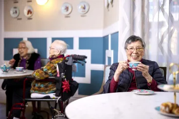 Image of 3 people in a nursing home drinking tea.