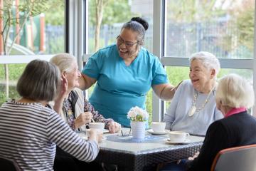 Image of 5 people sitting around table