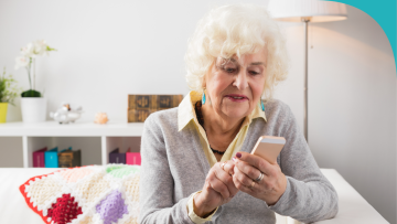 Elderly female looking at her mobile phone