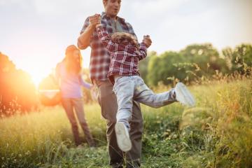 Image of a family playing in a field