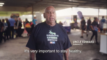 Man standing in public area being interviewed about shingles