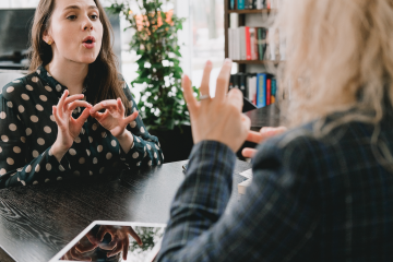 Photographic image of 2 women signing in Auslan