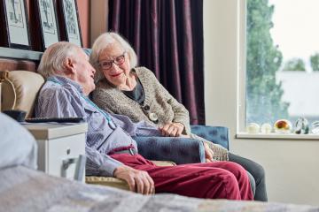 Photograph of an aged care couple sitting together