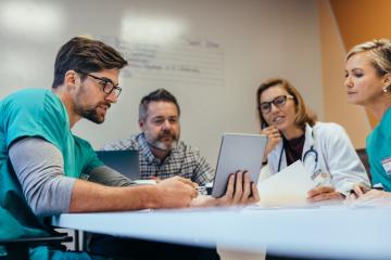 Photo of medical and consulting staff reviewing a report