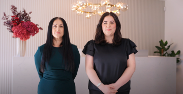 Screen capture from video with two women standing