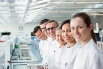Several lab technicians standing in a row