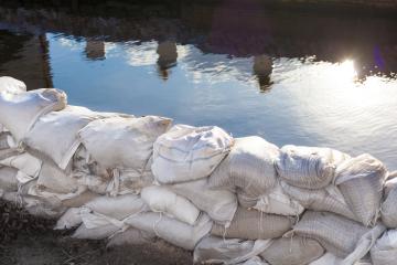 An image of sandbags holding back water