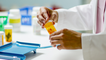 Lab technician holding a medicine container